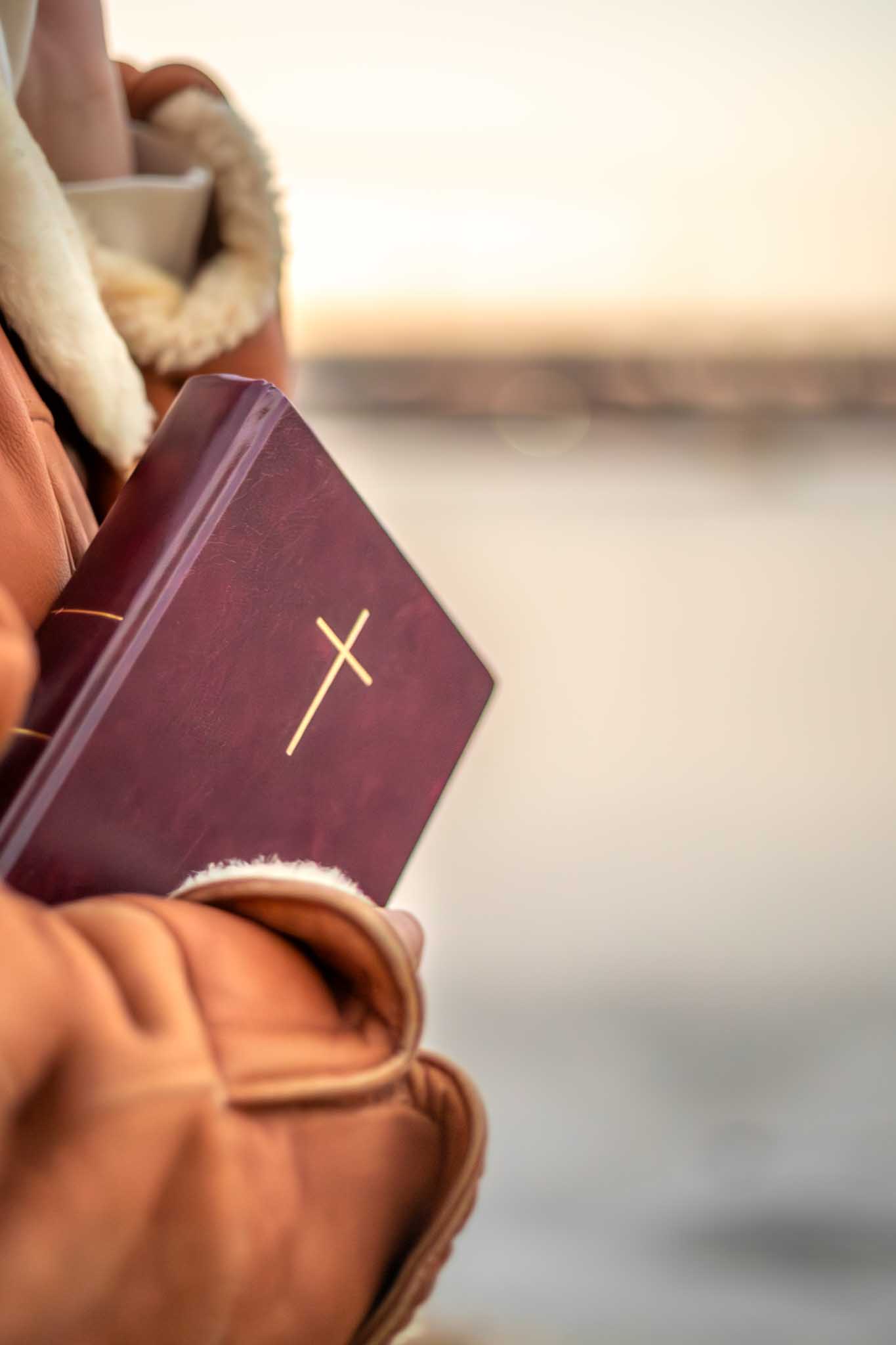 A person holding a Bible.